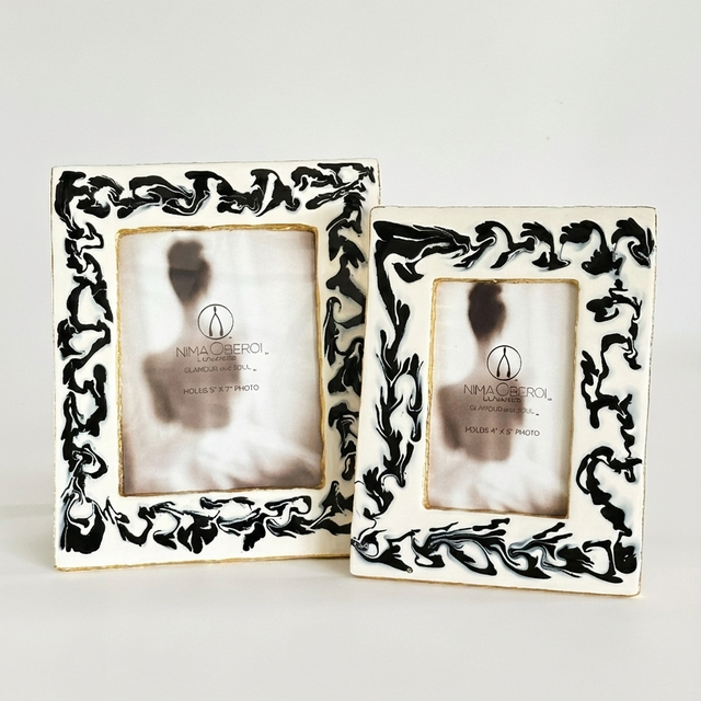 Two decorative picture frames with intricate black patterns on a white background