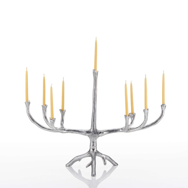 A silver tree-branch style candelabra with nine candle holders, shown with nine lit yellow taper candles on a clean white background.