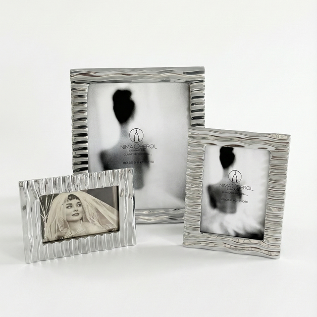 Three silver photo frames with different sizes on a white background