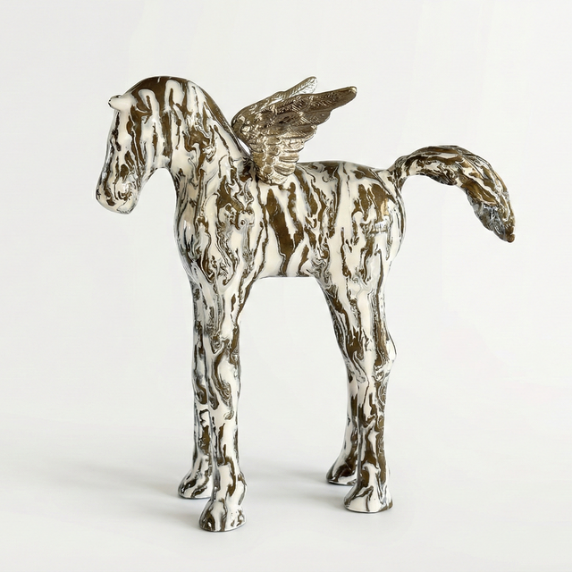 Metallic horse sculpture on a white background